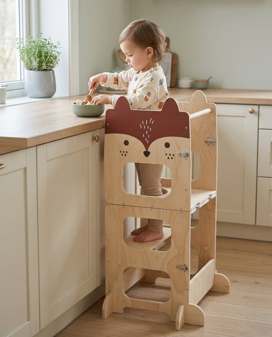 Enfant à la cuisine sur la tour d’apprentissage